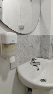 a bathroom with a white sink and a mirror at Los Arrieros - Hospedaje Rural in Manizales