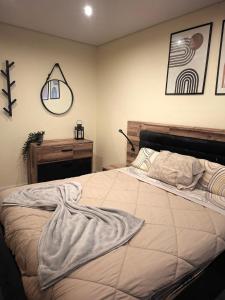 a bedroom with a large bed and a mirror at N3 Apartment in Amadora