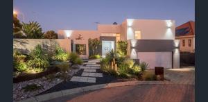 a large house with a driveway in front of it at The Studio on Barberry with a Pool in Perth
