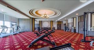 a gym with treadmills and exercise equipment in a building at Sunrise Sea View Apartment in Nha Trang