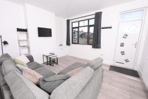 a living room with a couch and a tv at Spacious 6-Guest Retreat with Pool Table in Dinnington
