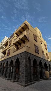 a large brick building with windows on top of it at بوتيك خان عطره in Medina