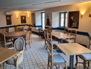 a dining room with wooden tables and chairs at Auberge de l'Etoile in Vignory