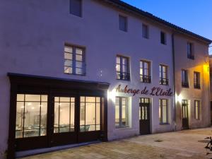 a white building with a sign that readsilage be killed at Auberge de l'Etoile in Vignory +27 photos