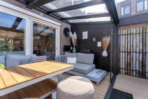 a screened in porch with a table and chairs at Hoek de luxe in Zoetermeer