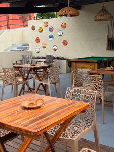 a patio with tables and chairs and a climbing wall at Casa vermelha Recanto Doce Lar in Gravatá