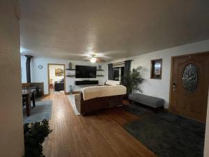 a living room with a couch and a tv at Cozy Little Dipper in North Pole