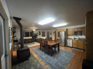 a kitchen with a table and a stove in a room at Cozy Little Dipper in North Pole