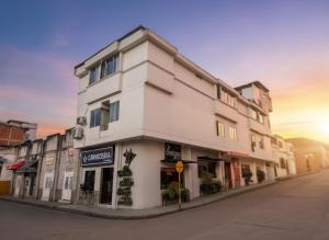 a white building on the side of a street at Casablanca Hotel, RestoBar, Catering, Eventos & Turismo en Garzón in Garzón