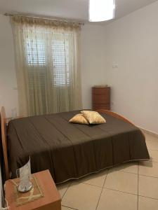 a bedroom with a bed with a pillow on it at Manilù House in San Prisco