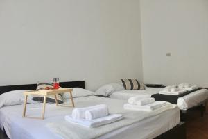 a room with two beds with towels on them at Iconic 3-BR Home Steps from Duomo in Milan +4 photos