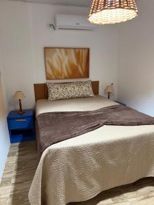 a bedroom with a large bed with two night stands and two lamps at Casa Laranja Recanto Doce Lar in Gravatá +17 photos