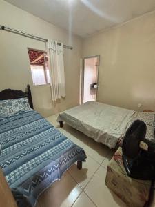 a bedroom with two beds and a window at Barbosa in Três Marias