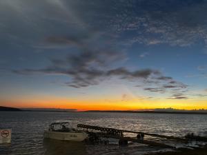 a boat is docked at a dock at sunset at Barbosa in Três Marias