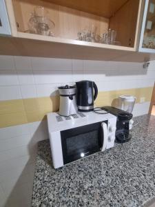 a microwave sitting on a counter in a kitchen at Appartement de luxe in Sidi Daoud