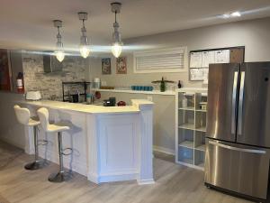 a kitchen with a counter and a refrigerator at Calgary Lake House B&B in Calgary