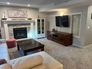 a living room with a couch and a fireplace at Calgary Lake House B&B in Calgary