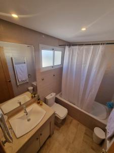 a bathroom with a sink and a toilet and a tub at Appartement de luxe in Sidi Daoud