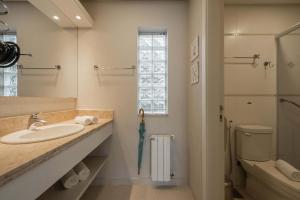 a bathroom with a sink and a toilet at Doce Canela - Pousada de Charme in Canela