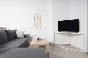 a living room with a couch and a flat screen tv at Hilltop Apartment 6 in Hanioti