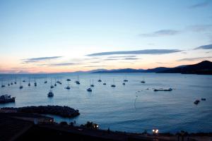 a group of boats in the water at sunset at Duplex sur la mer in LʼÎle-Rousse +5 photos