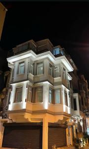 a tall white building at night with its lights on at La Mer Old City Hotel in Istanbul