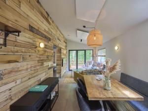 a dining room with a large wooden wall at Cabin 22 in Zutendaal