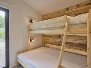a bunk bed in a tiny house at Cabin 22 in Zutendaal