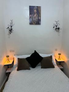 a bedroom with a bed with two lamps on it at Riad Dar khadija in Taroudant +12 photos