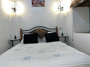 a bedroom with a bed with two night stands at Riad Dar khadija in Taroudant