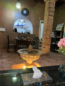 a fountain in the middle of a living room at Riad Dar khadija in Taroudant