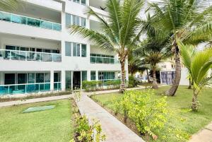 a building with palm trees in front of it at Palm Paradise Condo Pool & Beach in Punta Cana