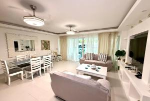 a living room with a couch and a table at Palm Paradise Condo Pool & Beach in Punta Cana