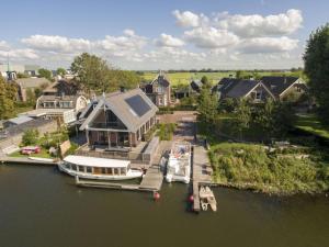 an aerial view of a house with boats in the water at Villa Kaagervaaring in Kaag
