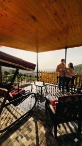 two people standing on the deck of a house at Alreem Farm in Ajloun
