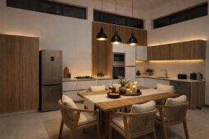 a kitchen with a table and chairs and a refrigerator at Fairview Holiday Villa in Rivière Noire