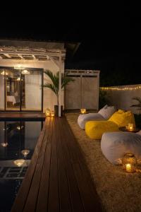 a room with two beds and a pool at night at Fairview Holiday Villa in Rivière Noire