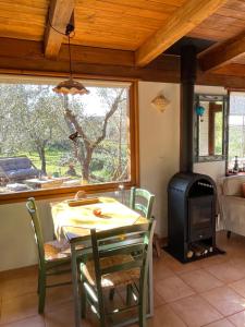 a dining room with a table and a wood stove at Chalet Mimosa in Itri