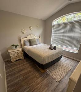 a bedroom with a bed and a large window at Welcome to LUX Guesthouse! in Ruskin