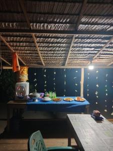 a blue table with plates of food on it at Mantorom homestay in Yennanas Besir +56 photos