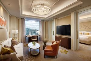 a living room with a couch and a tv at THE GRAND LOTTE SEOUL - Formerly known as Lotte Hotel Seoul in Seoul