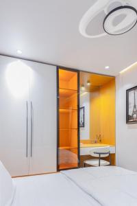 a bedroom with a large sliding glass door with a bathroom at Aiidraproperties in Lagos