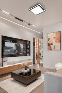 a living room with a tv and a couch at Aiidraproperties in Lagos