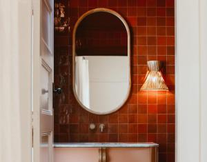 a bathroom with a mirror and a sink at Sona Molong in Molong