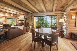 a dining room with a table and a couch at Trappers Cabin in Beaver Creek