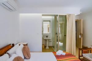 a bedroom with a bed and a bathroom with a shower at Casa Matriz Séc. XVI | Double or Twin w/ balcony in Penafiel +203 photos
