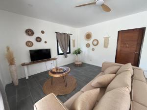 a living room with a couch and a table at Villa Sabaï • Private Pool • Thong Krut in Nathon Bay
