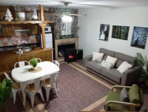 a living room with a couch and a table and a fireplace at El DESAFÍO in Riópar