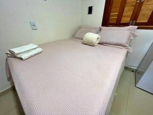 a bed with two towels on top of it at Pousada Chale Joana in Alter do Chao