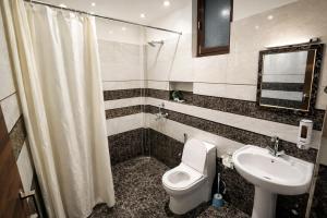 a bathroom with a toilet and a sink at Bajoon homestay in Bhīm Tāl +52 photos